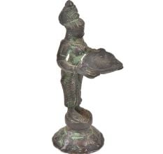 Bronze Lady Holding A Diya In Her Hand Is On A Raised Platform With Patina