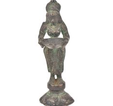 Bronze Lady Holding A Diya In Her Hand Is On A Raised Platform With Patina