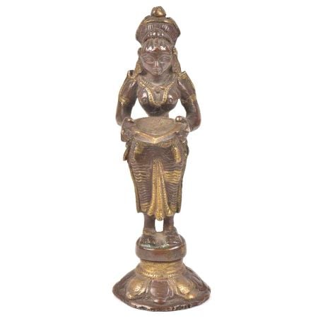 Bronze Lady Holding A Diya In Her Hand Is On A Raised Platform