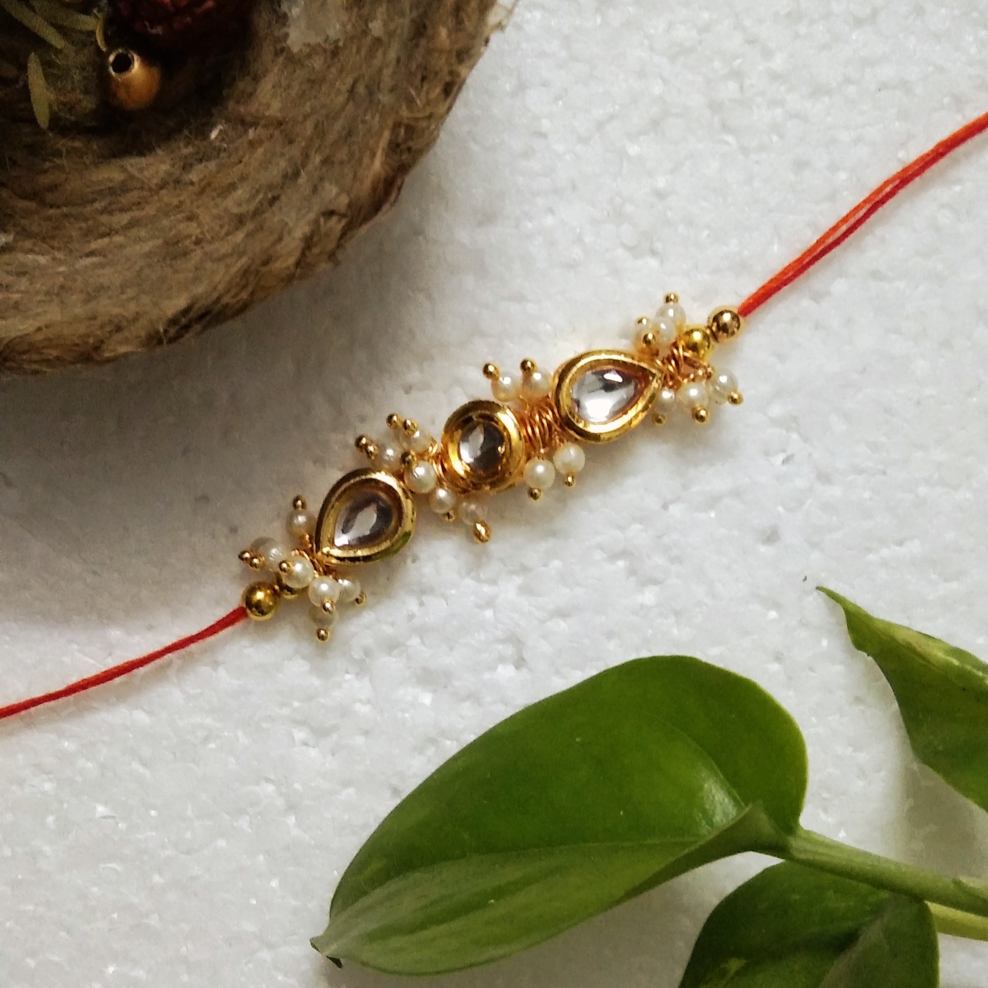 Traditional Rakhi with Kundan Beads, Acrylic, Metal, Wooden