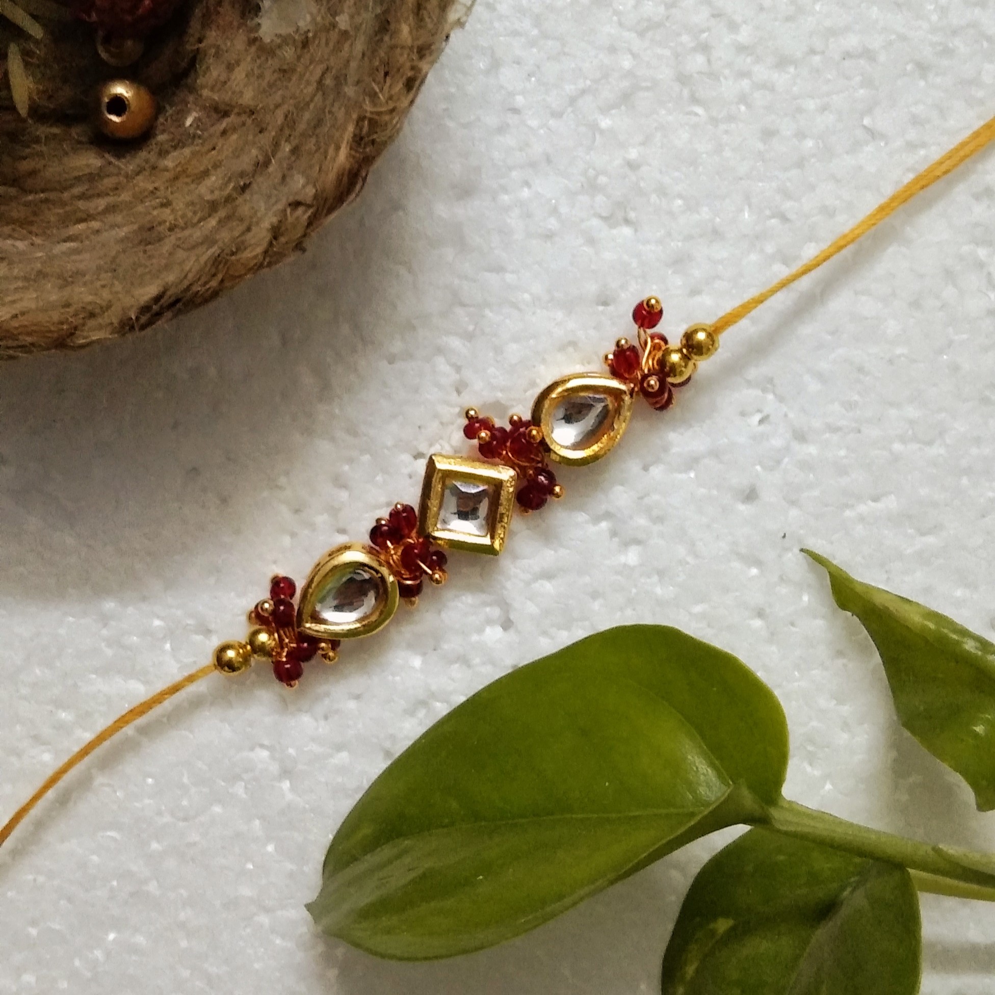 Traditional Rakhi with Wooden, Kundan Beads, Metal, Acrylic